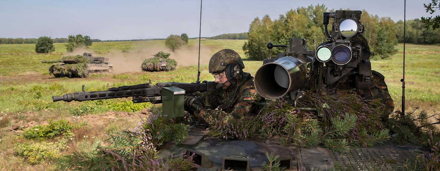 soldiers look at a monitor